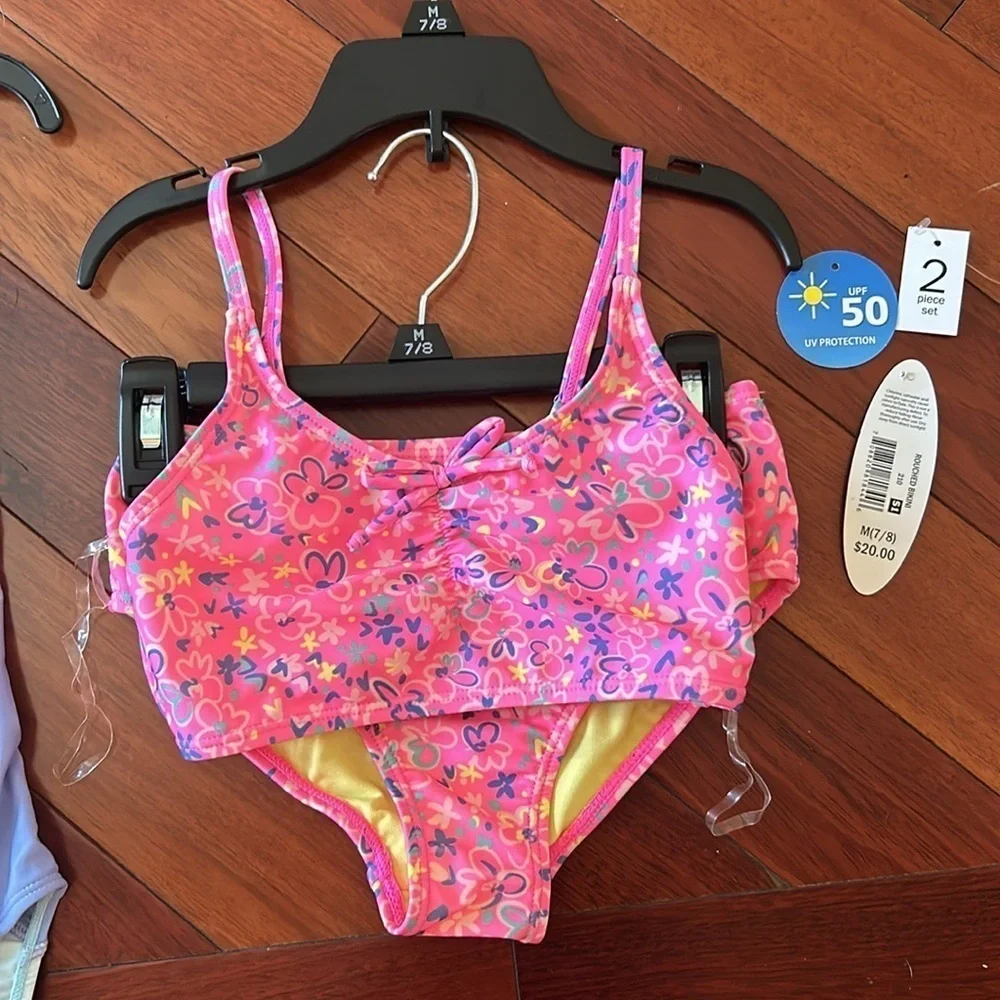 Girls set of swimsuits, pink set is a 7/8 and the one piece is a small.